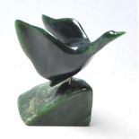 A vintage mid 20th century green jade coloured stone in a shape of flying goose , mounted on a