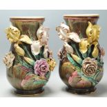 A pair of late 19th century Victorian large Majolica baluster vases, having applied floral details