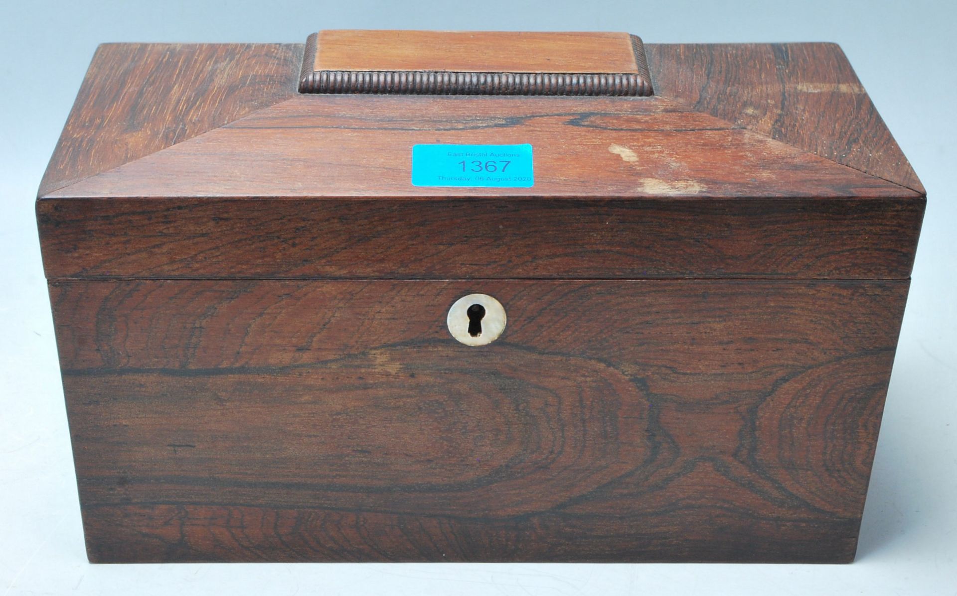 A 19th Century Victorian rosewood tea caddy of sarcophagus form with a mother of pearl escutcheon,