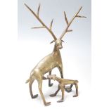 A 20th Century Indian folk art cast brass figurine of a horn deer suckling a fawn with incised
