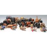 A large collection of vintage 20th century hand carved wooden elephants of various sizes having hand