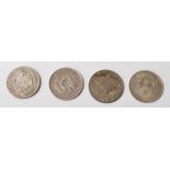 A group of four silver world coins to include a Memento Birth of Republic of China silver coin, a