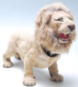 A vintage mid-century retro nodding head lion with brown plastic eyes, mane around the articulated