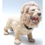 A vintage mid-century retro nodding head lion with brown plastic eyes, mane around the articulated