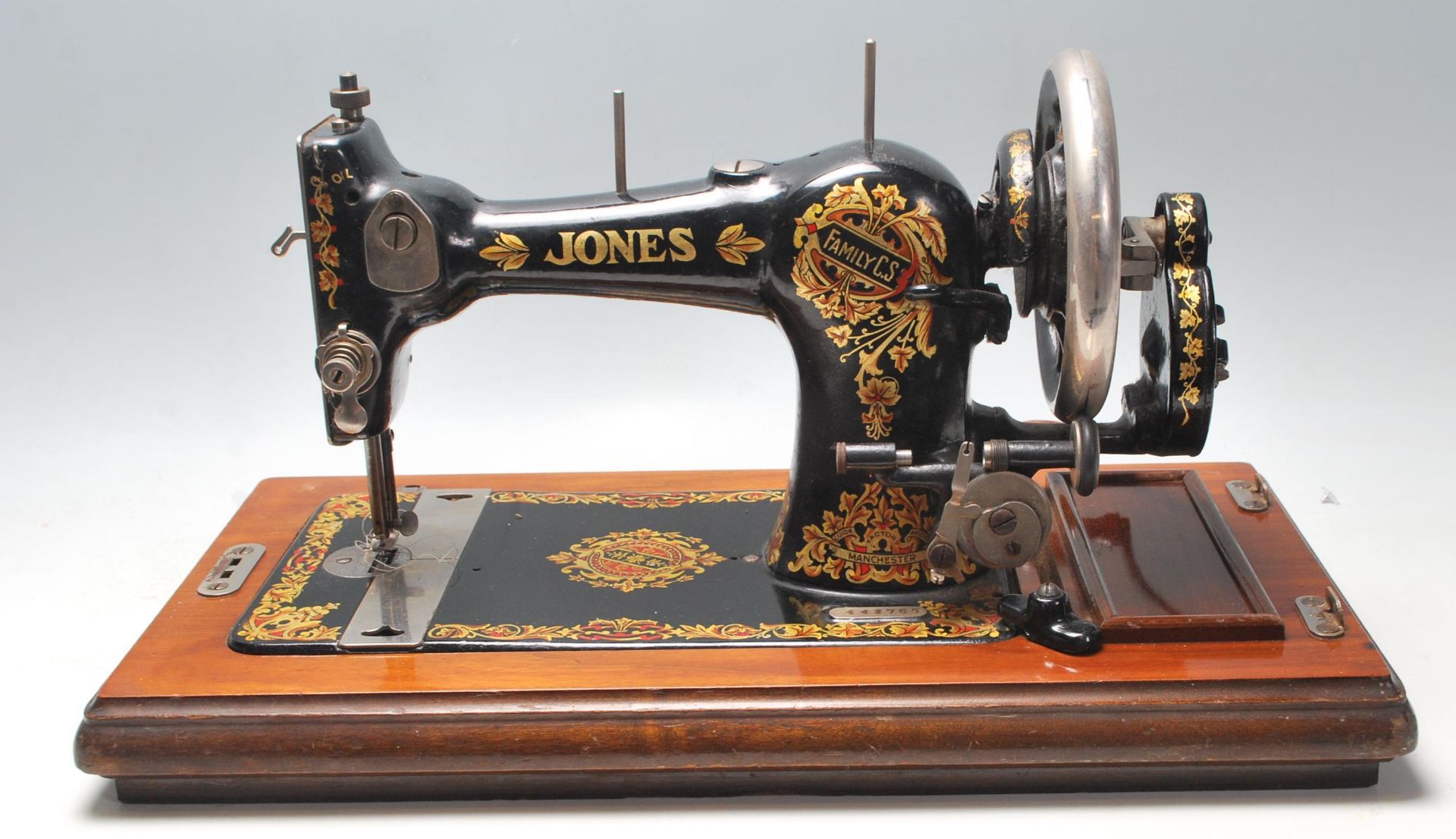 An original vintage mid century sewing machine by Jones Family painted black with gilt floral