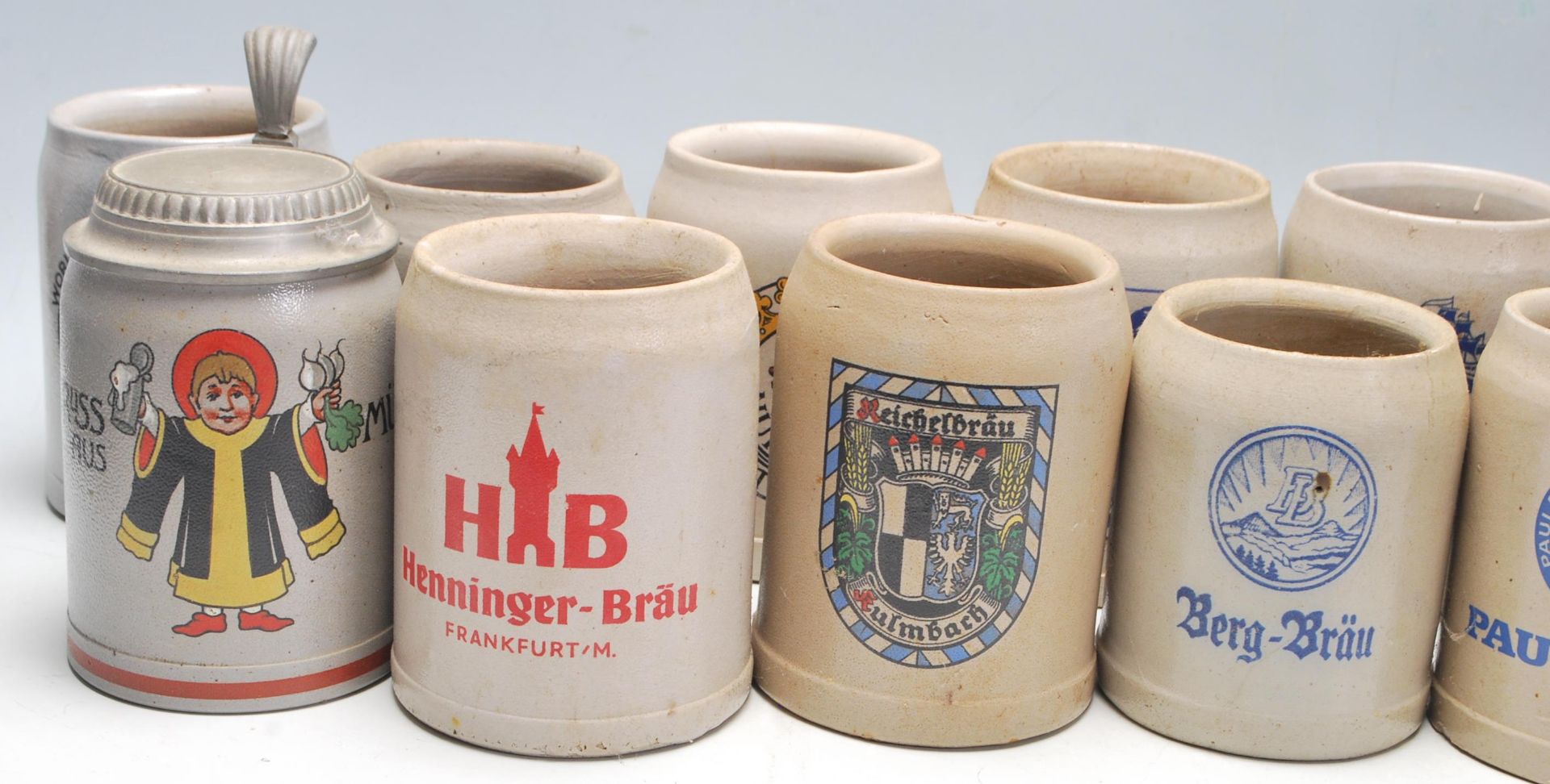A large collection of 20th Century German blue and grey stoneware jugs and beer steins all having - Image 4 of 7