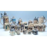 A large collection of German blue and grey stoneware jugs and beer steins, some having pewter
