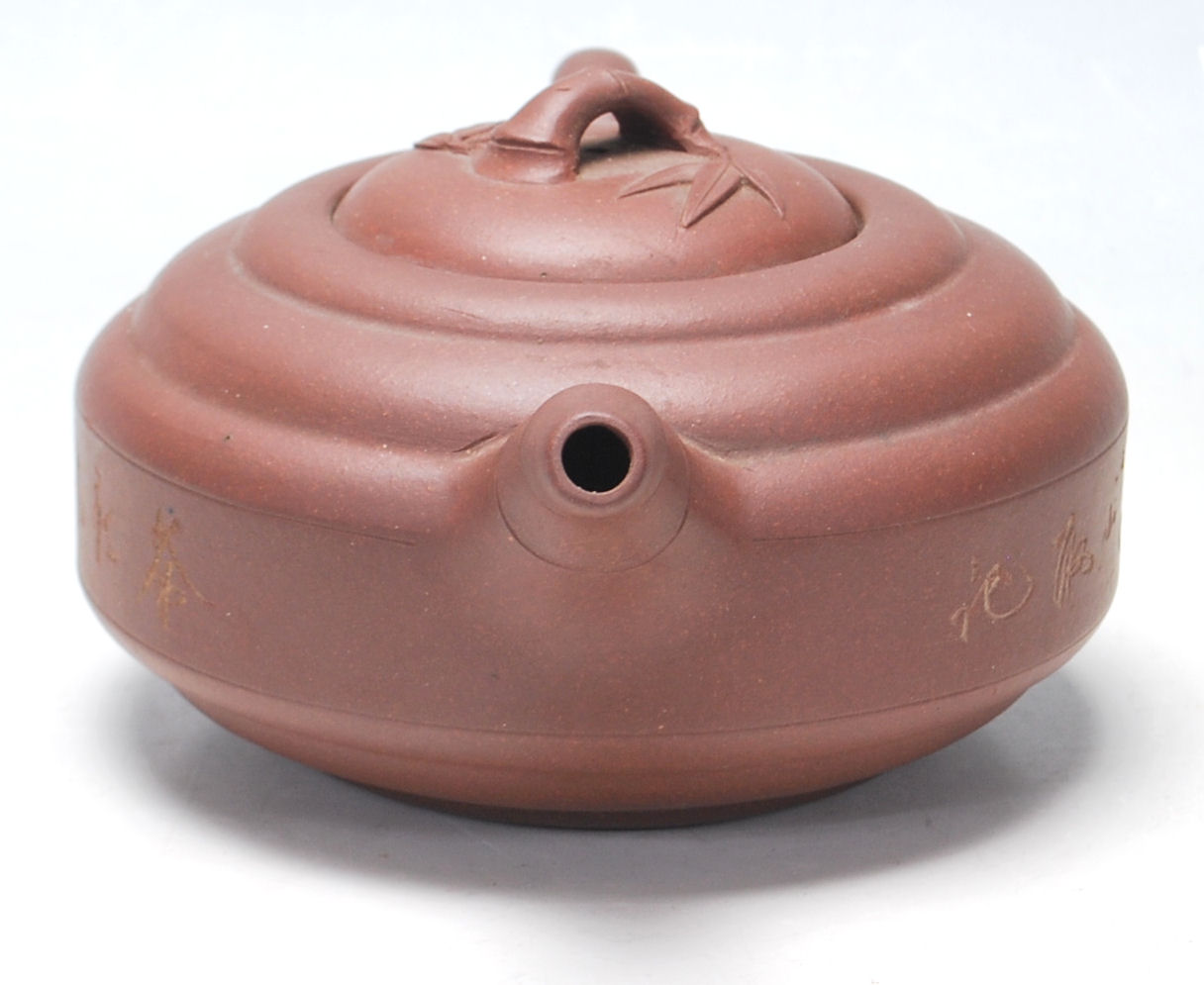 A 20th Century Chinese red clay Yi Xing teapot of round stepped form having a bamboo formed spout - Image 2 of 7