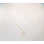 An 18ct ladies necklace having a heart shaped pendant set with diamond accent stones on a 18ct cable