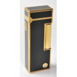 A vintage retro Dunhill lighter having black enamelled panels throughout with gilt borders, roller