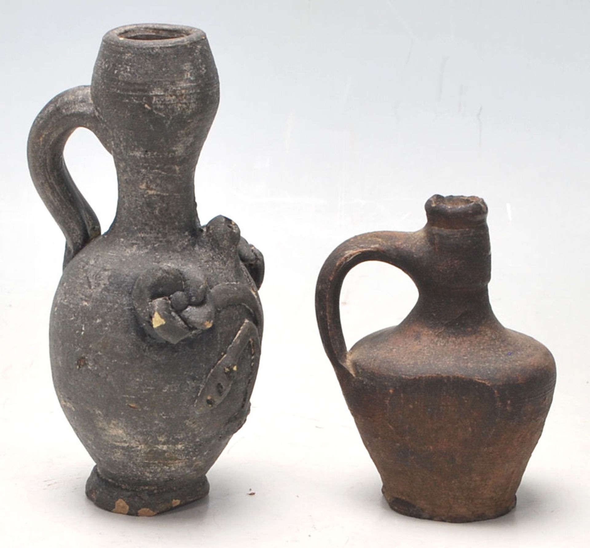 Two antique 16th Century style stoneware hand modelled jugs to to include an oil jug with applied - Image 3 of 7