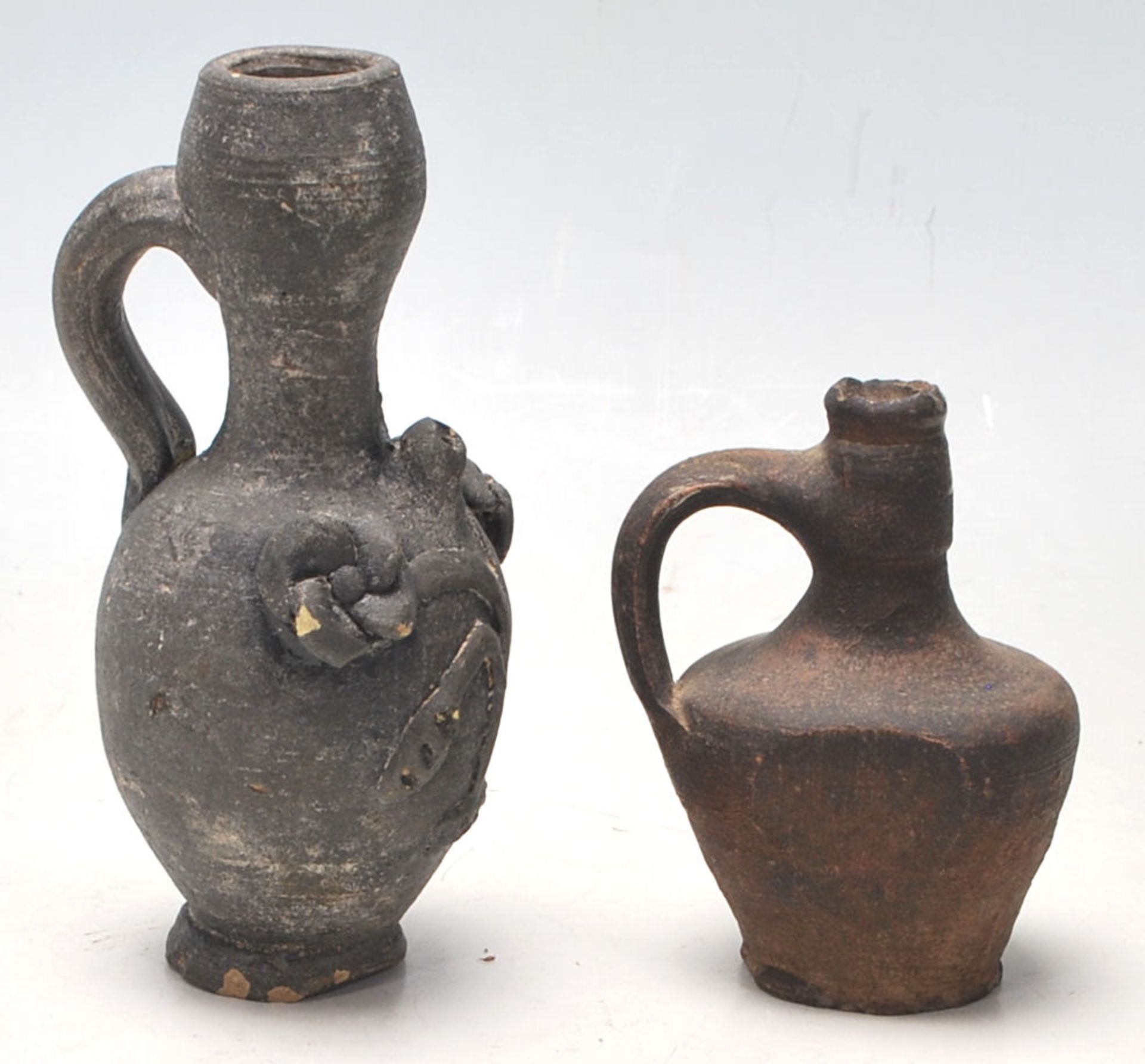 Two antique 16th Century style stoneware hand modelled jugs to to include an oil jug with applied - Bild 3 aus 7