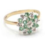 A hallmarked 9ct gold green and white stone cluster ring having a round cluster of green and white
