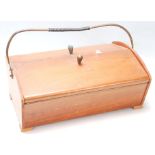 A retro vintage mid 20th century Danish teak sewing box with two flaps opening to reveal a sectional