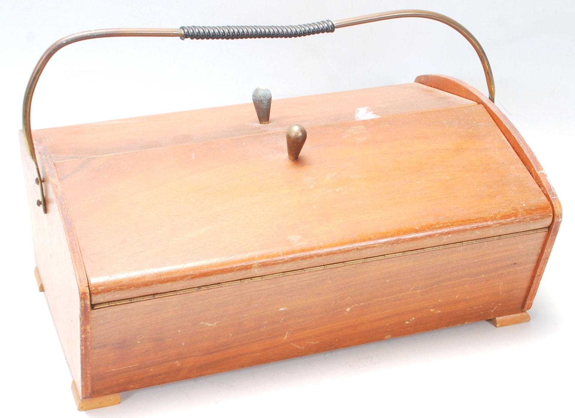 A retro vintage mid 20th century Danish teak sewing box with two flaps opening to reveal a sectional