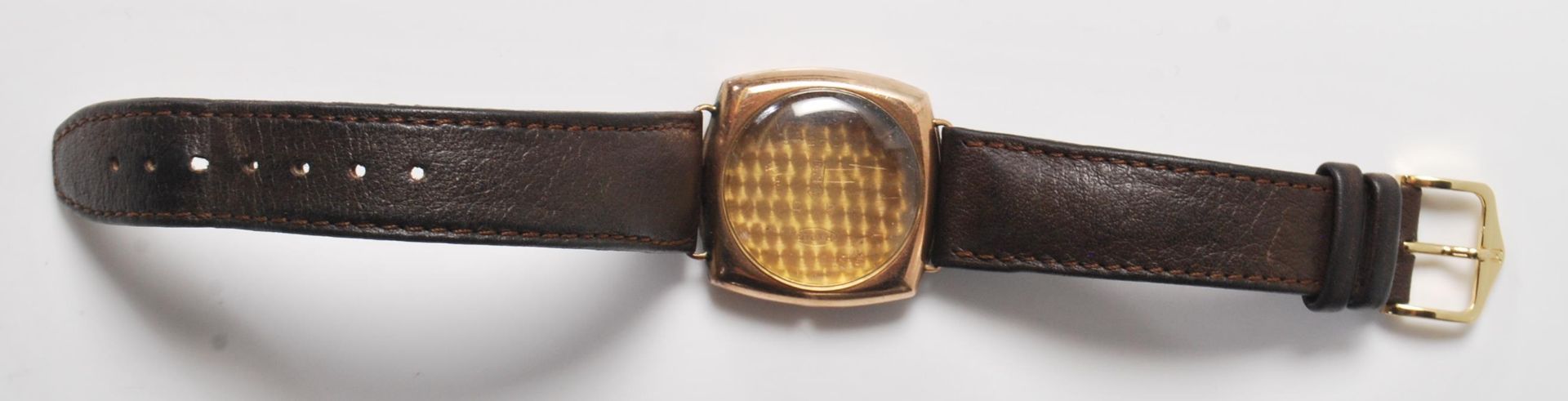 A 9k gold R.W.C.Ltd hallmarked wristwatch case with brown leather strap having 375 and letter “