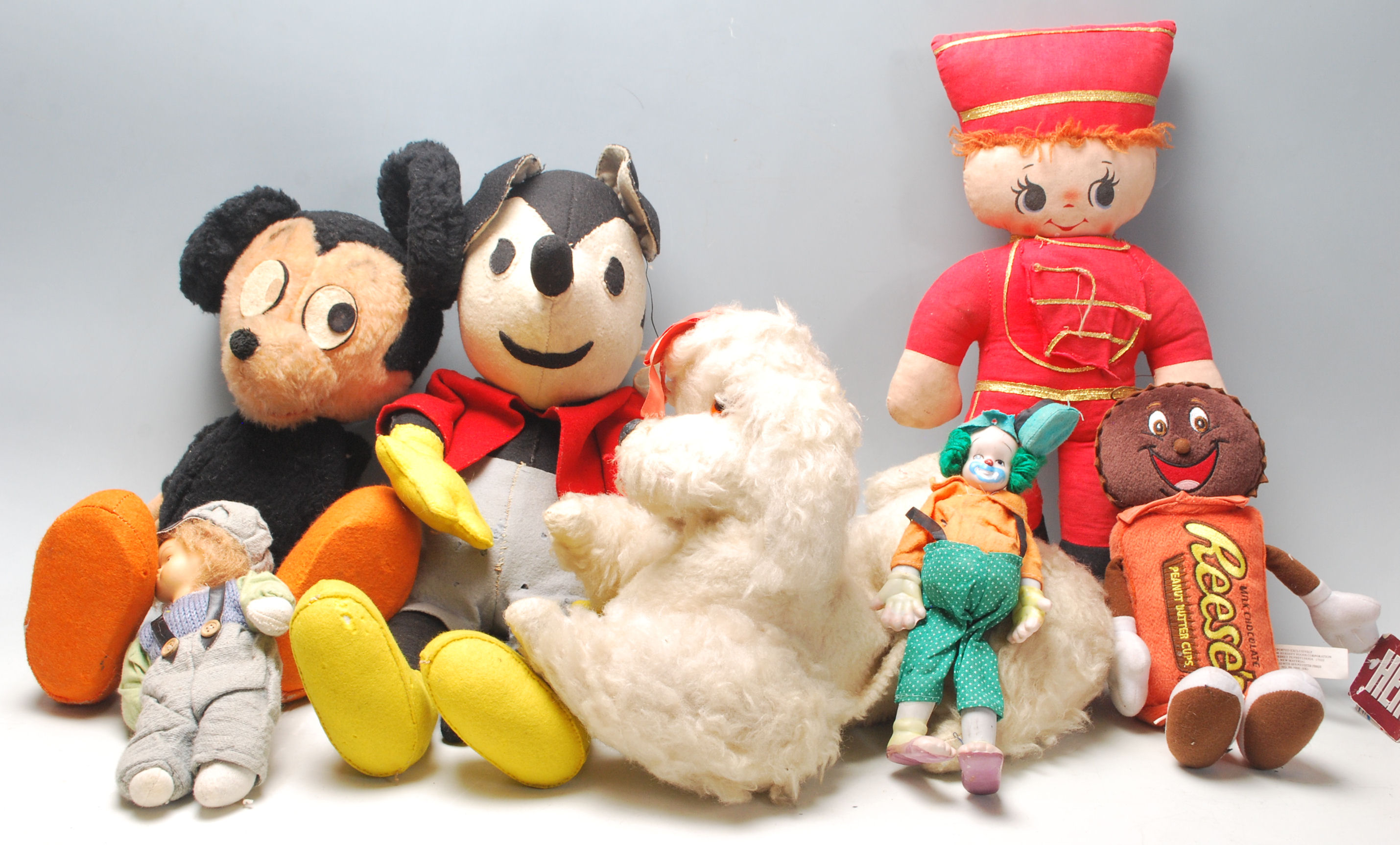 A collection of mid 20th century soft toys to include two Mickey Mouse and others in a vintage brown