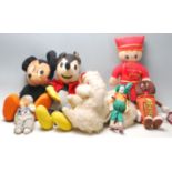 A collection of mid 20th century soft toys to include two Mickey Mouse and others in a vintage brown