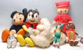 A collection of mid 20th century soft toys to include two Mickey Mouse and others in a vintage brown