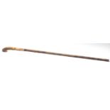 A 19th Century antique walking stick cane having a faux bamboo carved shaft with a gold collar and a
