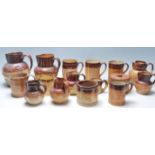 A collection of 19th Century Victorian ceramic Harvest ware jugs / drinking vessels / flagons,