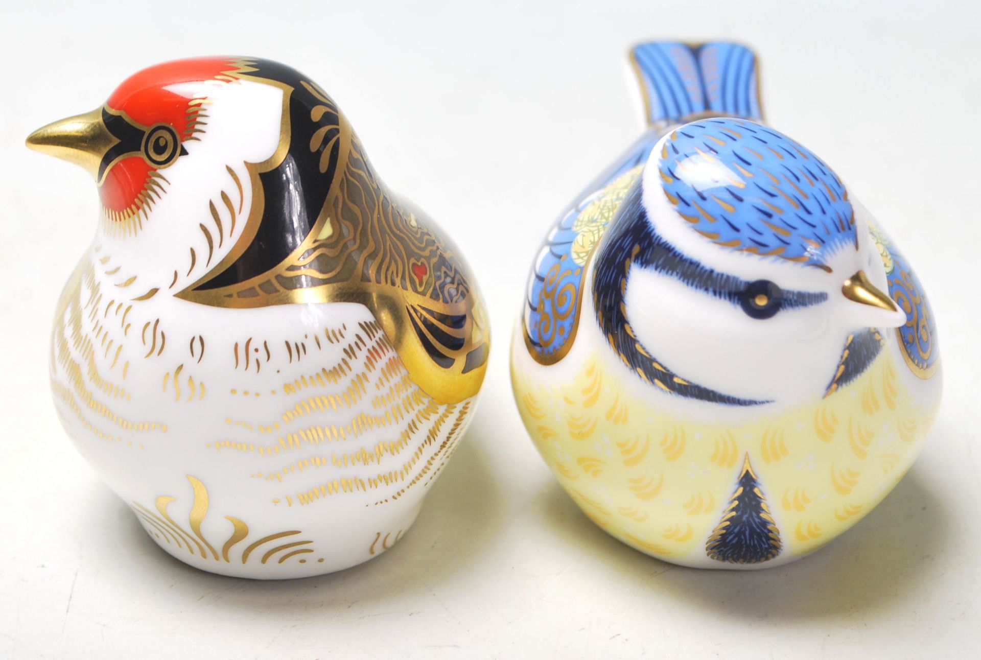A pair of Royal Crown Derby paperweights both in the shape of birds to include Garden Blue Tit and a