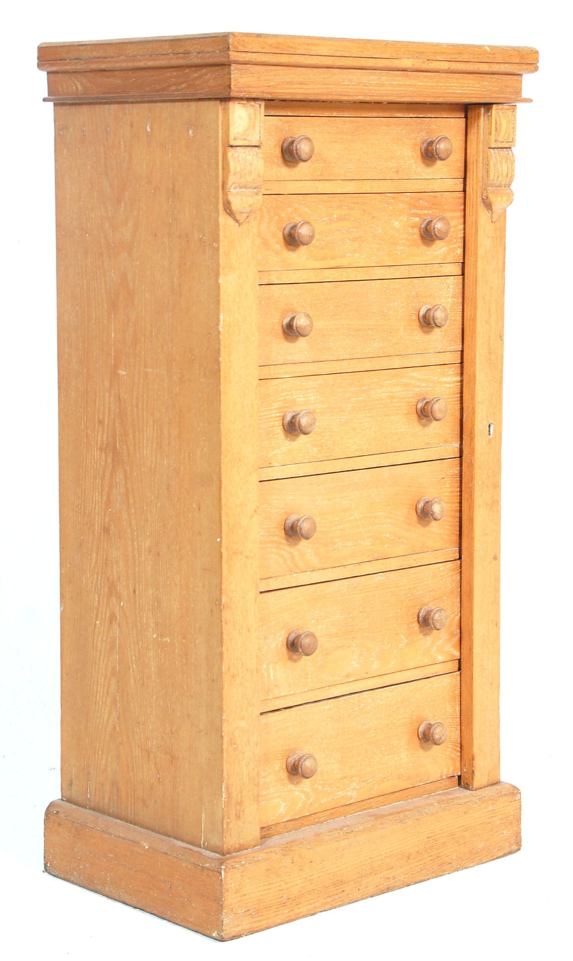 A 19th Century Victorian light oak Wellington chest of drawers. Raised on a plinth base with an