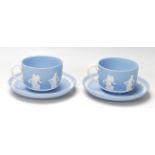 A pair of antique early 20th century Wedgwood dancing hours Jasperware tea cups and saucers with