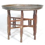 An early 20th Century antique tray opium table raised on six fruit wood legs united by stretchers