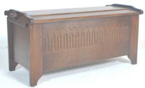 A good Jacobean revival 20th Century oak blanket box with a hinged dome top opening to reveal