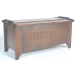 A good Jacobean revival 20th Century oak blanket box with a hinged dome top opening to reveal