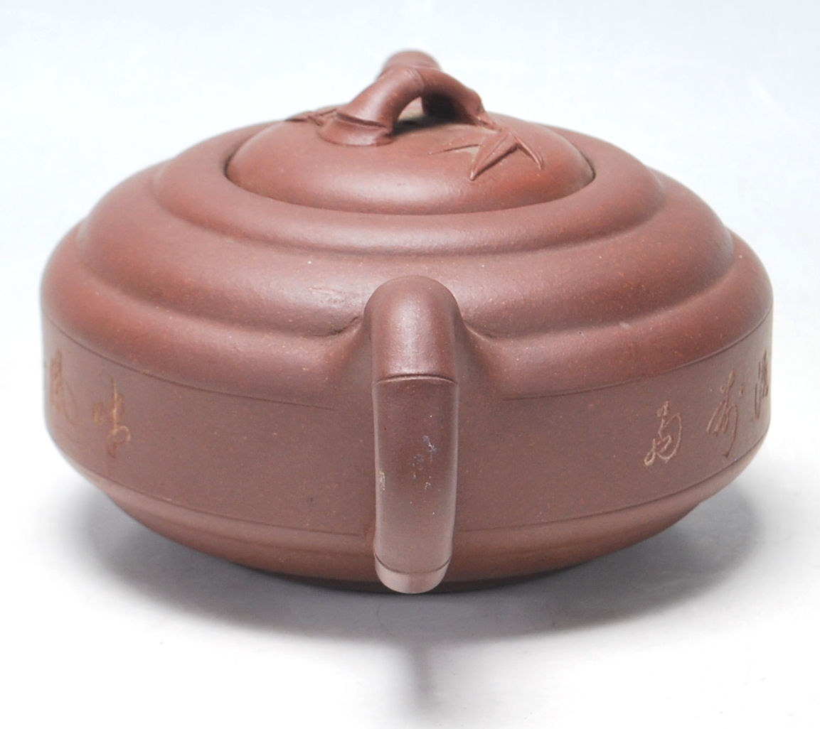 A 20th Century Chinese red clay Yi Xing teapot of round stepped form having a bamboo formed spout - Image 4 of 7