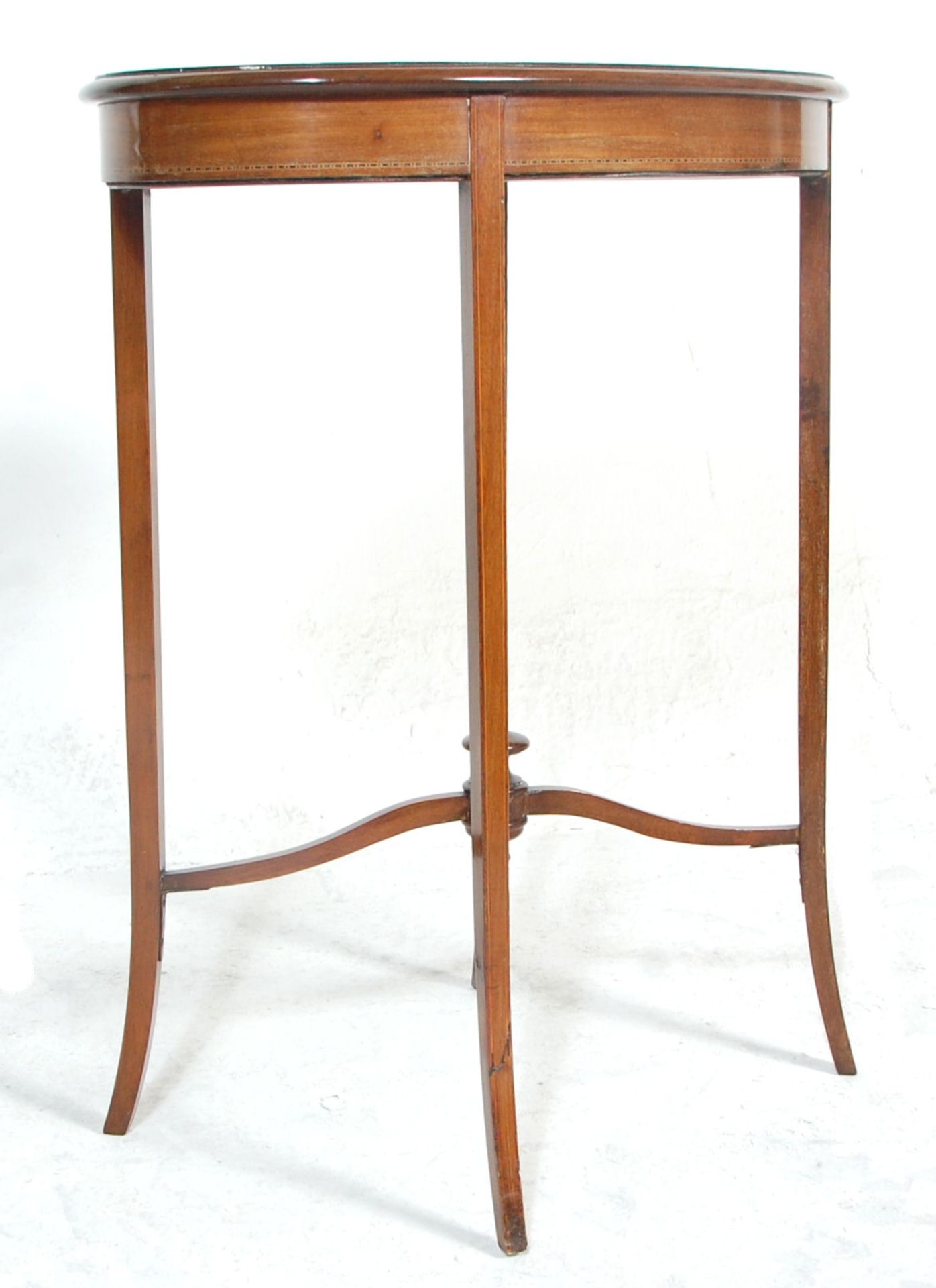 An Edwardian mahogany hall side table having an oval top with a diamond veneer and satinwood