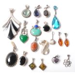 A collection of mixed vintage silver mounted pendants, most being set with coloured stones to