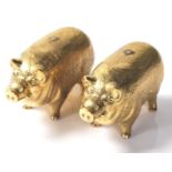 A pair of 18ct gold plated salt and pepper shakers in the shape of pot bellied pigs. Stamped 18ct