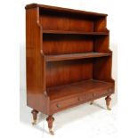 A good mid 20th century mahogany waterfall bookcase having gallery back, two graduating shelves