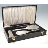 A vintage hallmarked sterling silver vanity set comprising of a silver mirror, silver hair brush,