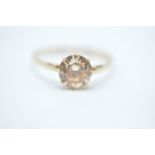A hallmarked 9ct gold ring having a central white stone within a cathedral setting and pierced