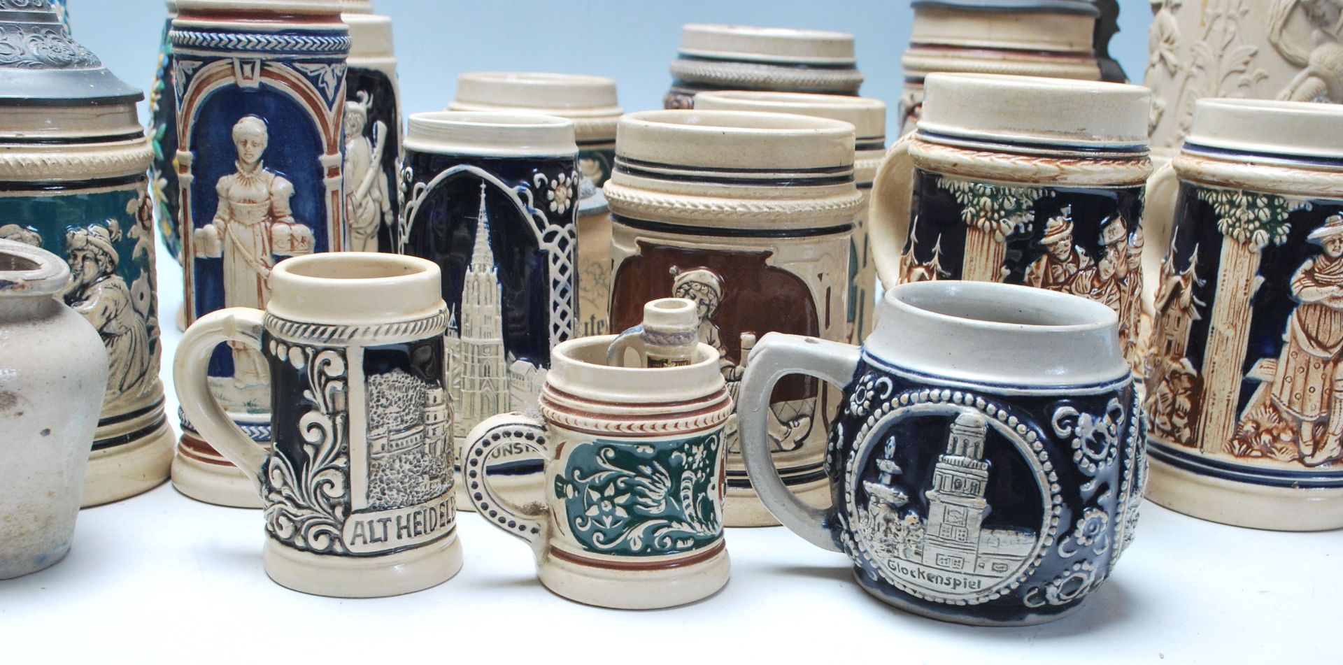 A large collection of German blue and grey stoneware jugs and beer steins, some having pewter - Image 2 of 11