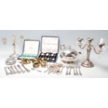 A collection of 20th Century silver plated wares to include a two branch armed candlesticks, two