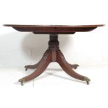 A 20th Century antique mahogany tilt top pedestal  dining table having a round top raised on a