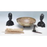 A collection of vintage tribal artefacts including an ashanti bronze in the shape of a bird, a