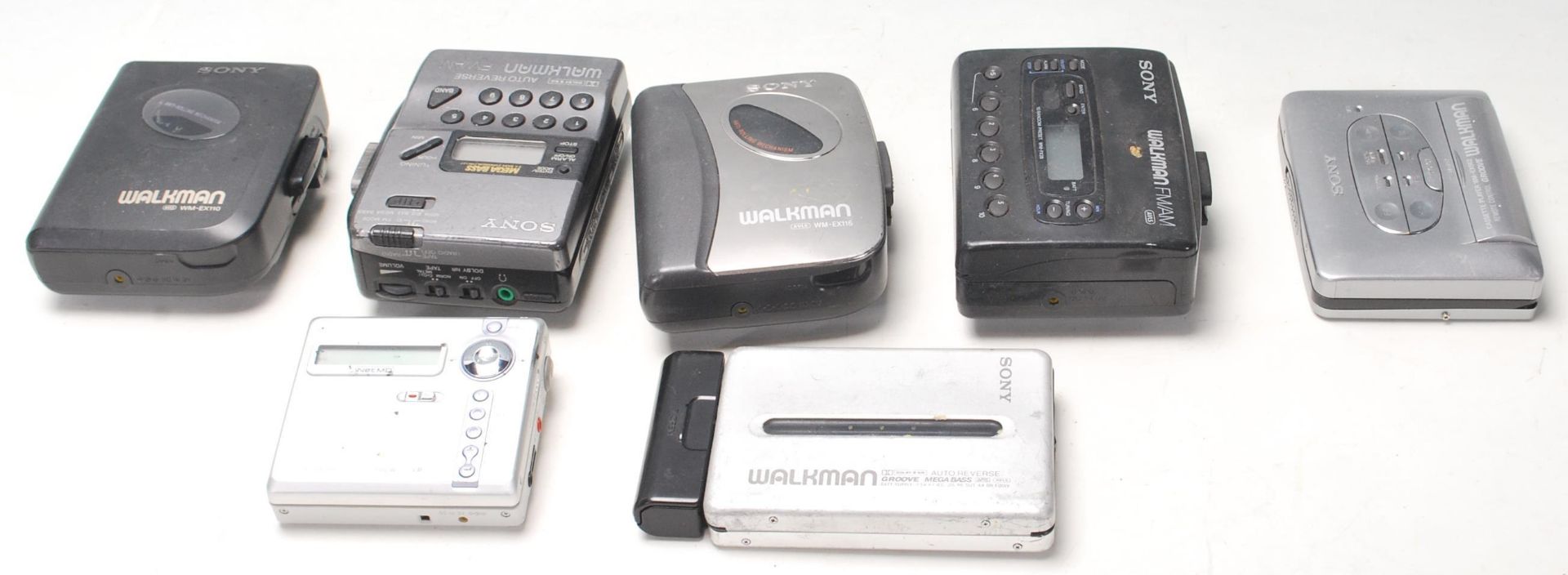 A collection of seven original vintage retro SONY made Walkman portable cassette player / radio.