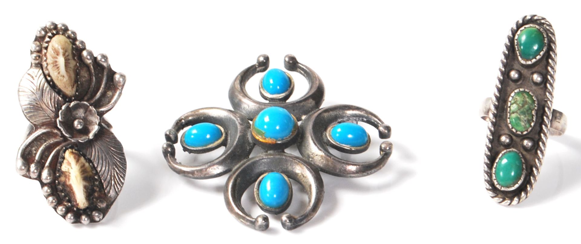 A group of silver white metal Native American Navajo rings to include one floral design ring set