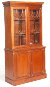 A good George III revival 20th century mahogany library bookcase cabinet having a carved frieze