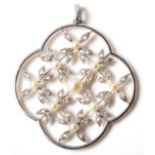 An early 20th Century Edwardian Belle Epoch platinum, diamond and pearl pendant of quatrefoil form