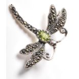 A stamped .925 silver and marcasite ladies dress brooch in the form of a dragonfly with a central