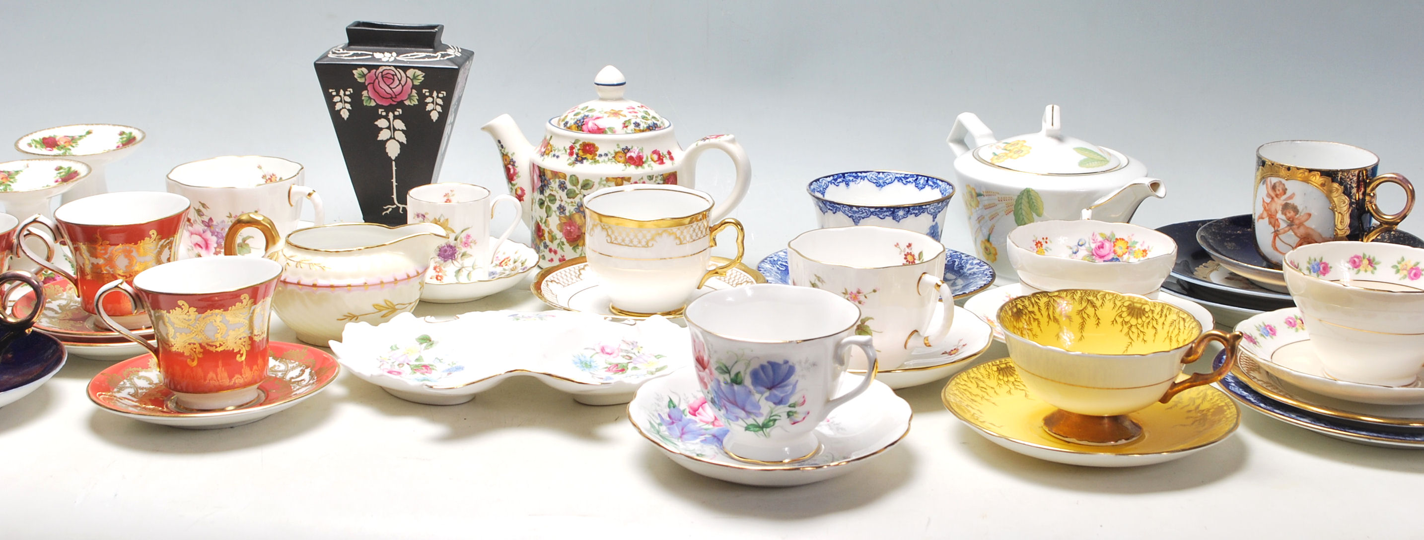 A collection of mixed vintage 20th Century mostly English china tea cups to include a Shelley rose