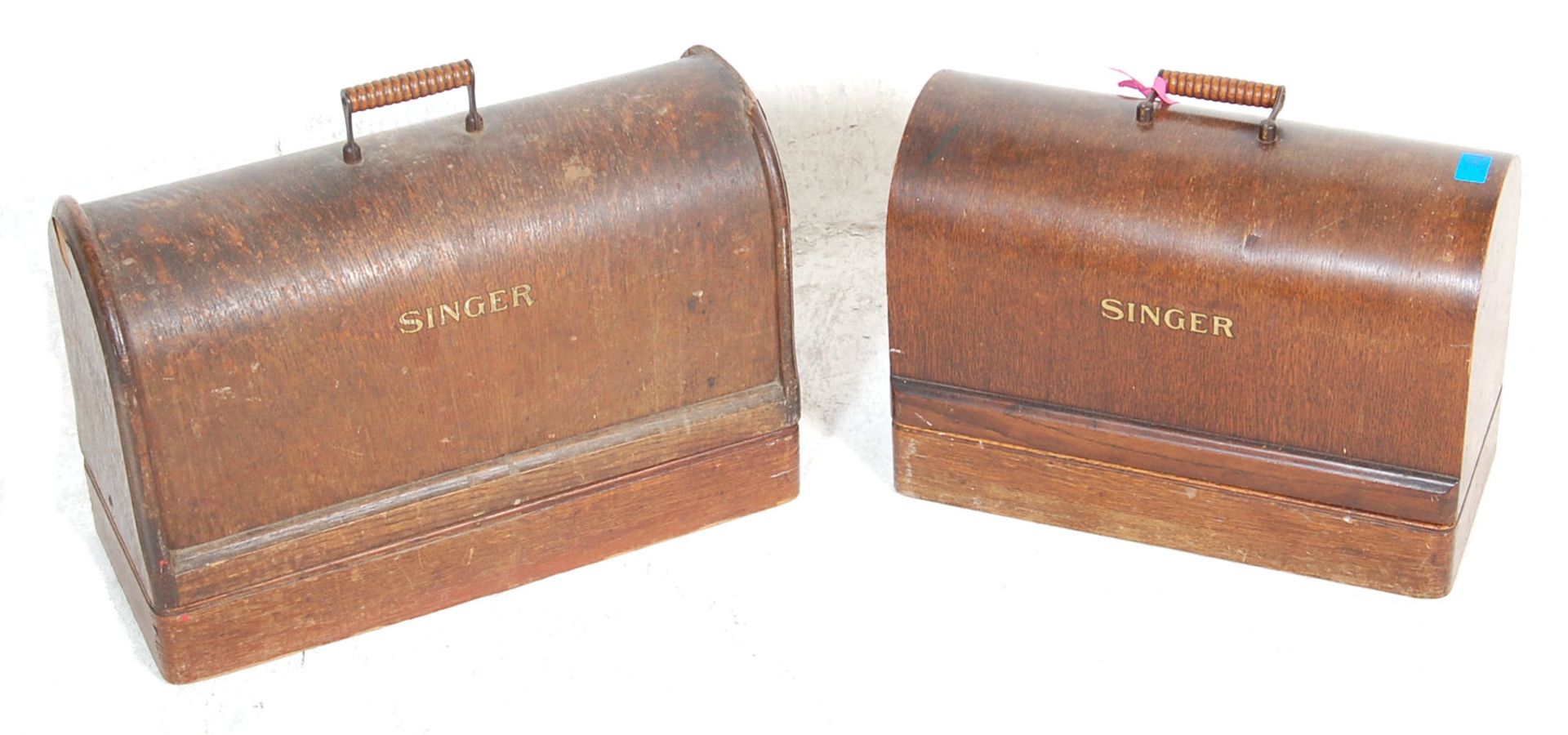 A pair of mid 20th century 1950s Singer sewing machines both coloured in black with gold floral