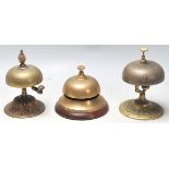 A group of three 20th century antique brass desk top ring bells having the typical dome top,
